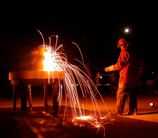 Fireman Slicing Fire Hydrant with Torch, Burning Man photo